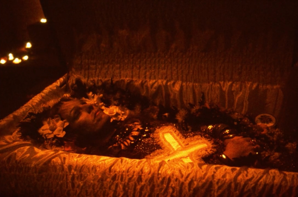 Cookie's corpse lying in an open coffin.
